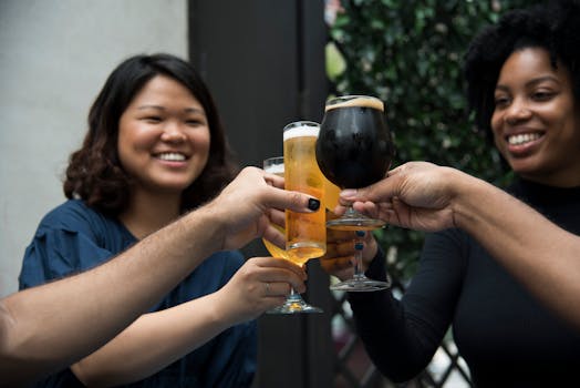 A joyful group of friends toasting with beer, symbolizing celebration and friendship in an outdoor setting.